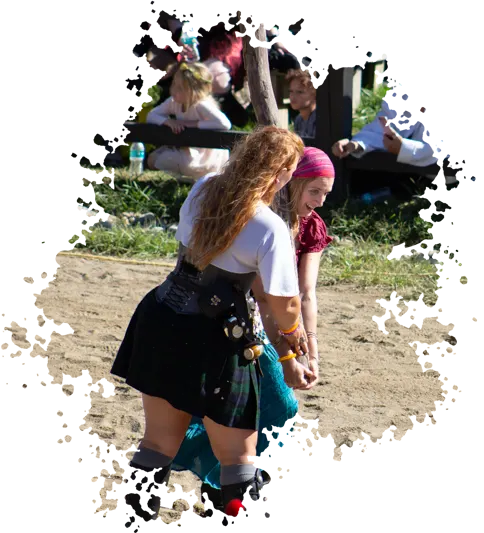 a Ohio Renaissance Festival guest holds a caber as a strong woman in a kilt helps her balance