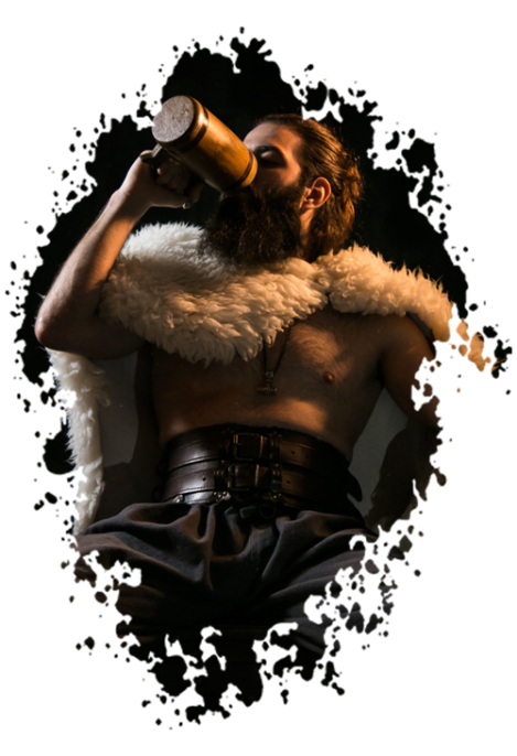 a buff viking man in furs drinks mead