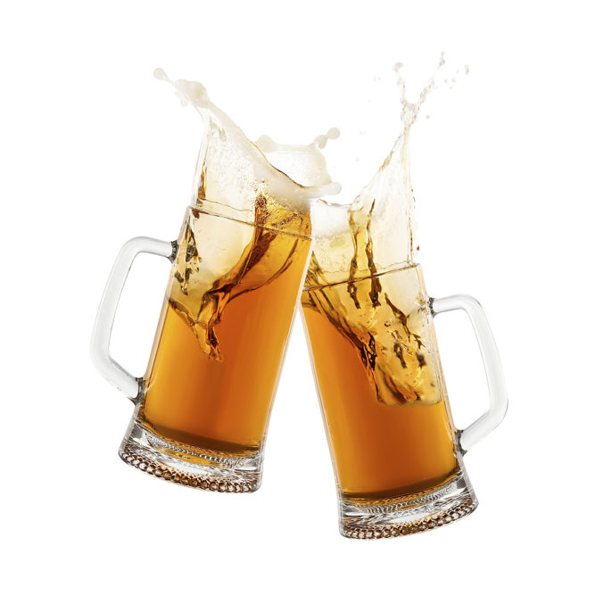 Two glass mugs of beer toasting with splash on white background