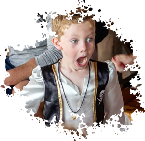 a young boy dressed in a Renaissance costume has a surprised look on his face